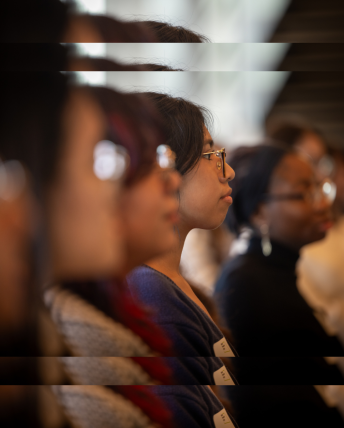 A blurred photo of three Break Through Tech fellows sitting side by side.