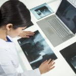 A doctor uses a computer to examine medical imaging data