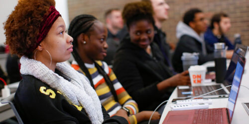 Three Black women at the University of Illinois at Chicago listen to Professor Dale Reed in a computer science course