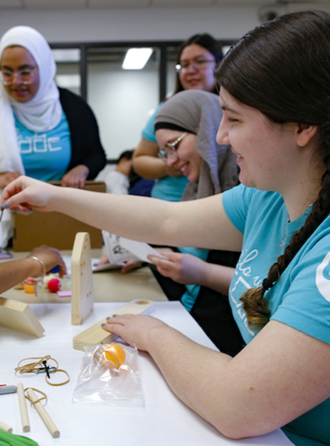 Gina Gerace, UIC '21, works on an activity with Girls Who Code participants at UIC