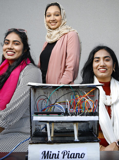 Ammara Ashraf, Farah Iqbal, and Sarah Iqbal with their UIC Engineering Expo creation: a high-tech mini piano.