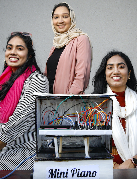 Ammara Ashraf, Farah Iqbal, and Sarah Iqbal with their UIC Engineering Expo creation: a high-tech mini piano.