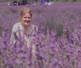 UIC computer science and linguistics student Grace Pnacek in a field of lavender flowers