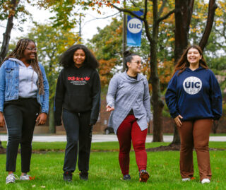 Four Break Through Tech members walking on UIC's campus