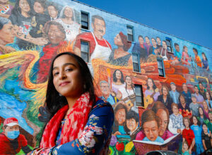 a UIC computer science student against a colorful mural artwork in Pilsen