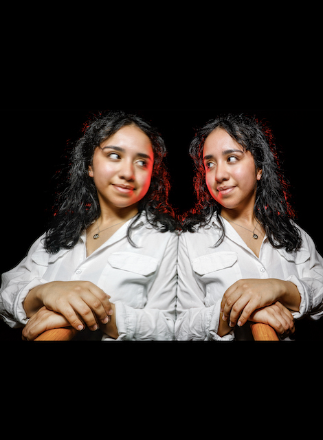 mirror-image style portrait of Monse Castillo against a dark black background